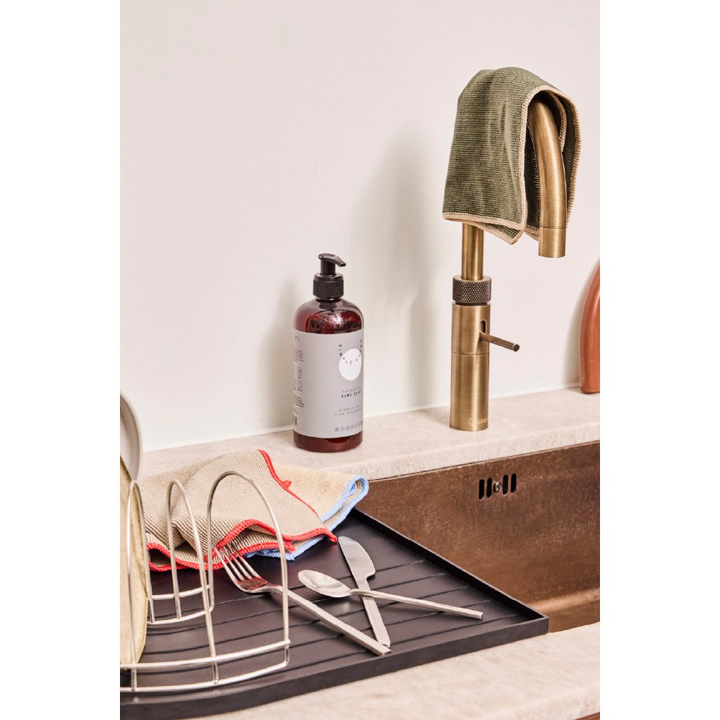 Dish drying rack with cutlery, dish soap, and towels on a kitchen counter.