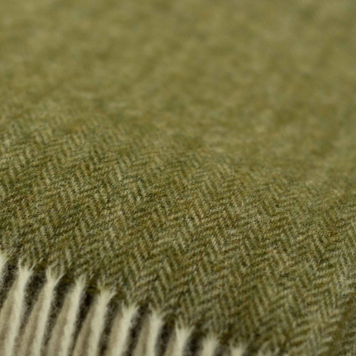 Close-up of a green fabric with a herringbone pattern