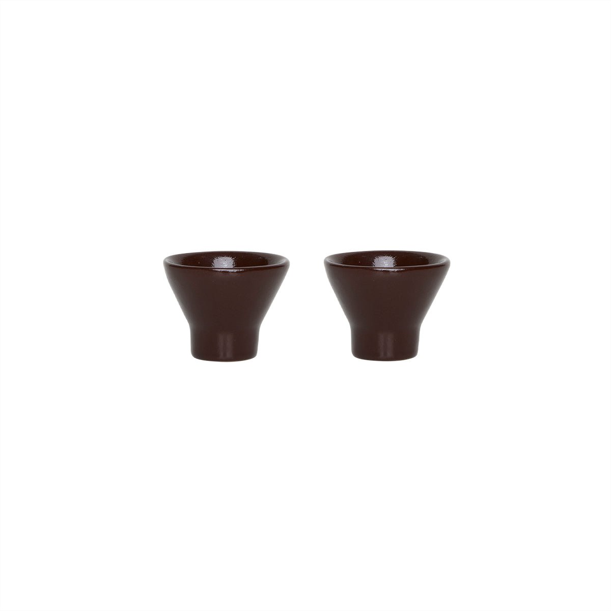 Two terracotta ceramic egg cups on a white background