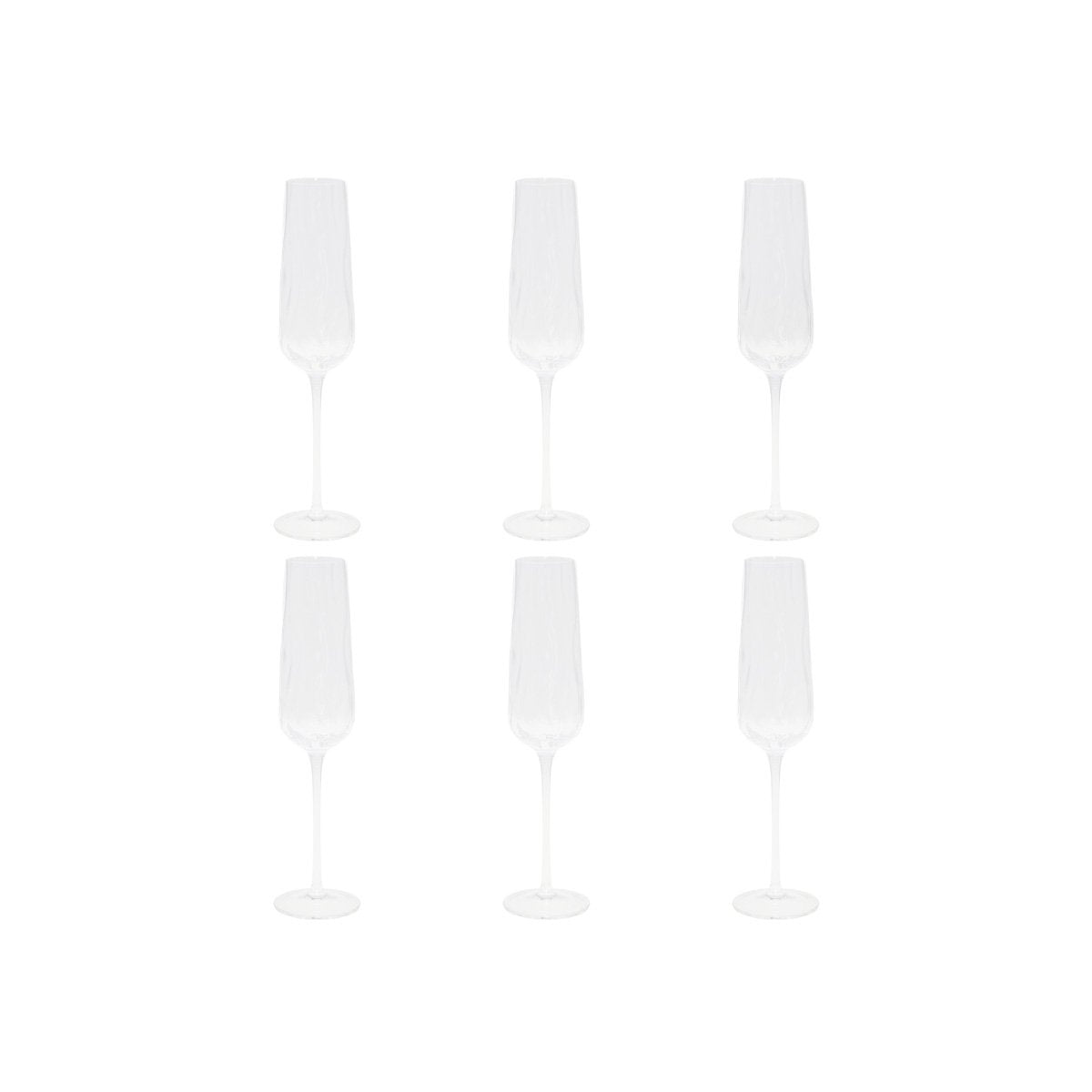 Set of four glass champagne flutes on a white background