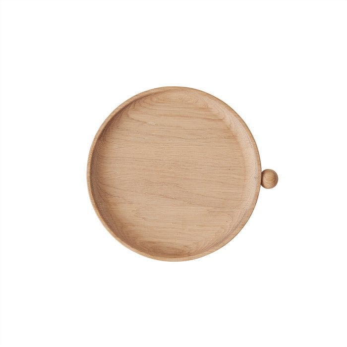 Wooden plate with a small knob on a white background