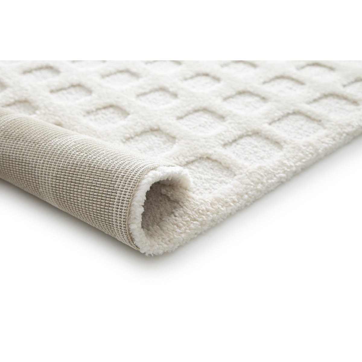 Close-up of a textured cream rug on a white background