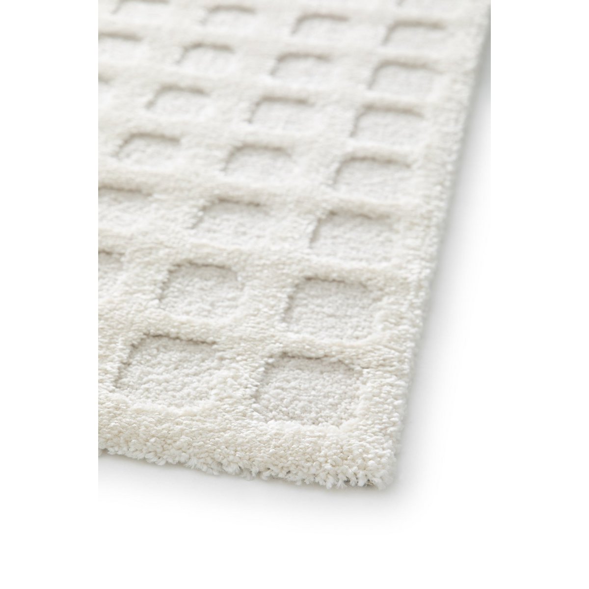 Textured cream rug with geometric pattern on a white background