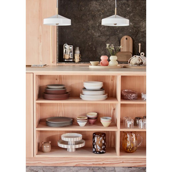 Wooden shelf with ceramic plates and bowls in a kitchen setting