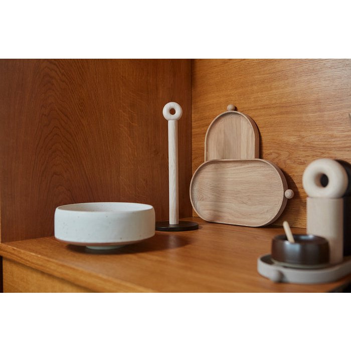 Decorative items including a white bowl, wooden trays, and ceramic pieces on a wooden surface.