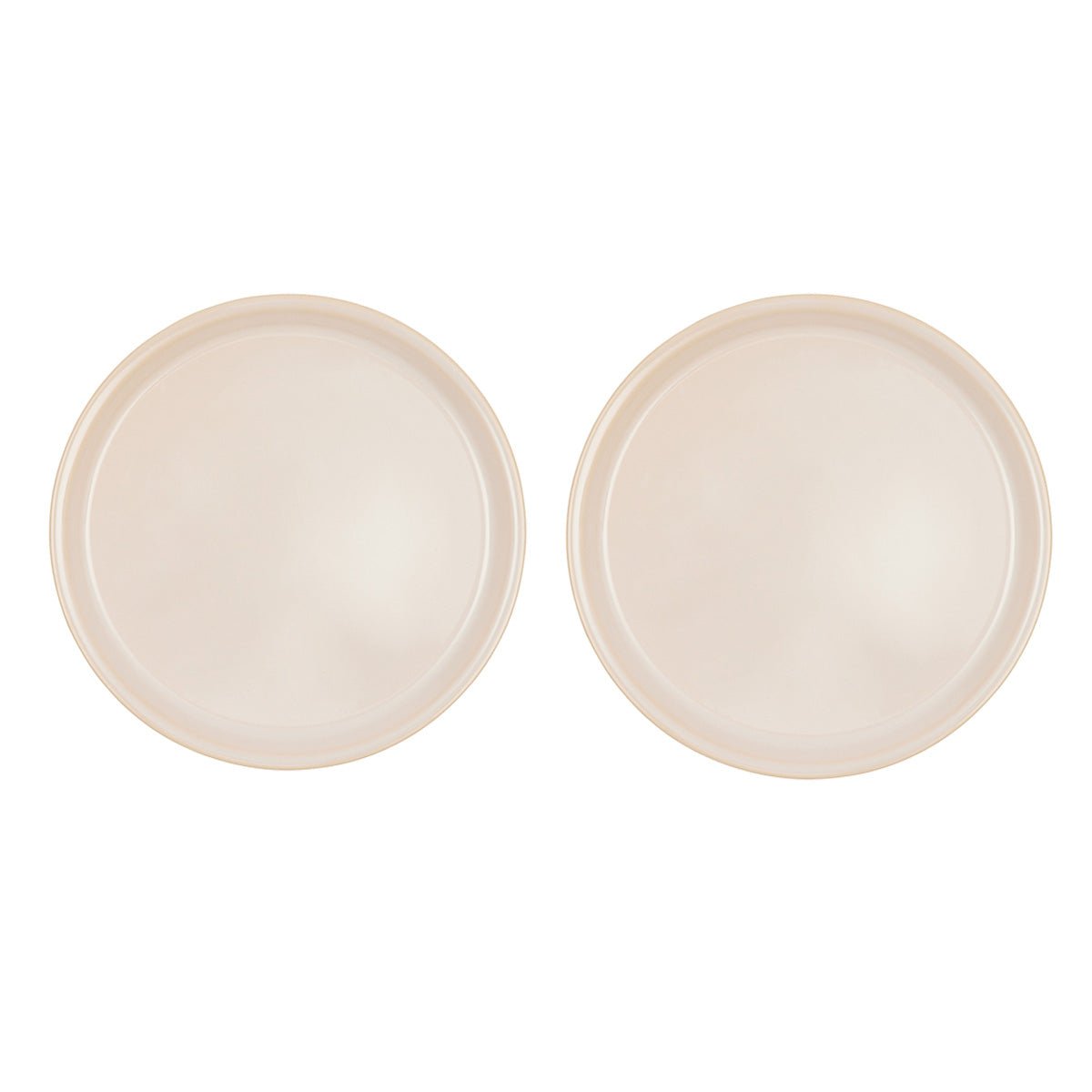 Two beige ceramic plates on a white background