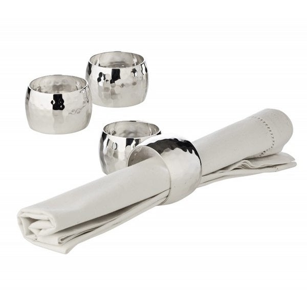 Silver napkin rings and a folded white napkin on a white background