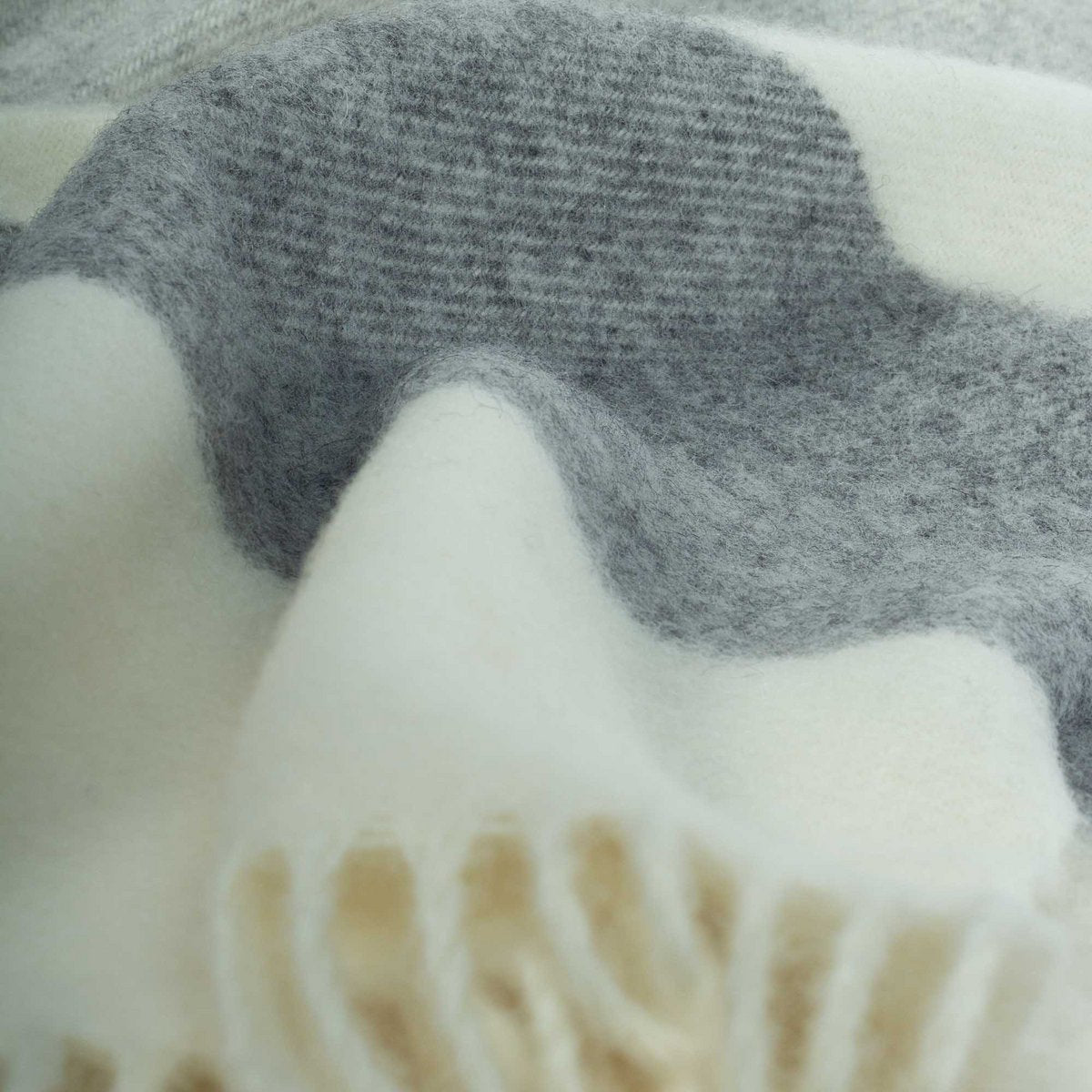 Close-up of a textured fabric with gray, white, and brown colors.