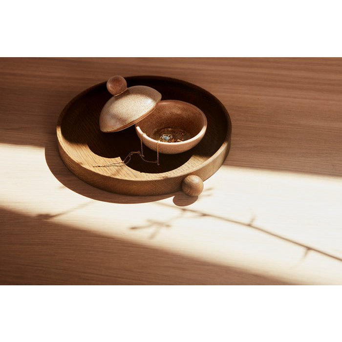 Wooden jewelry box with a ring inside on a wooden surface