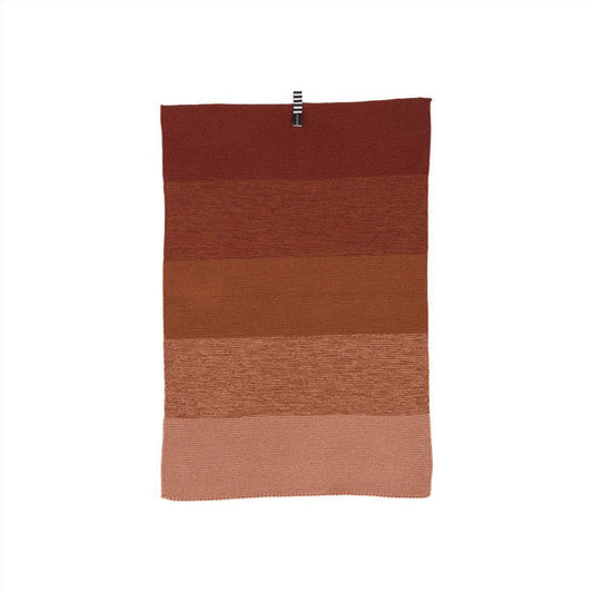 Gradient red and brown fabric on a white background