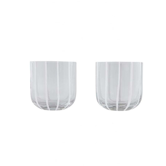 Two clear glass tumblers with white striped design on a white background
