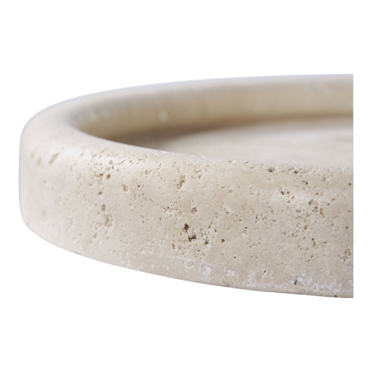 Close-up of a beige travertine dish with a textured surface on a white background