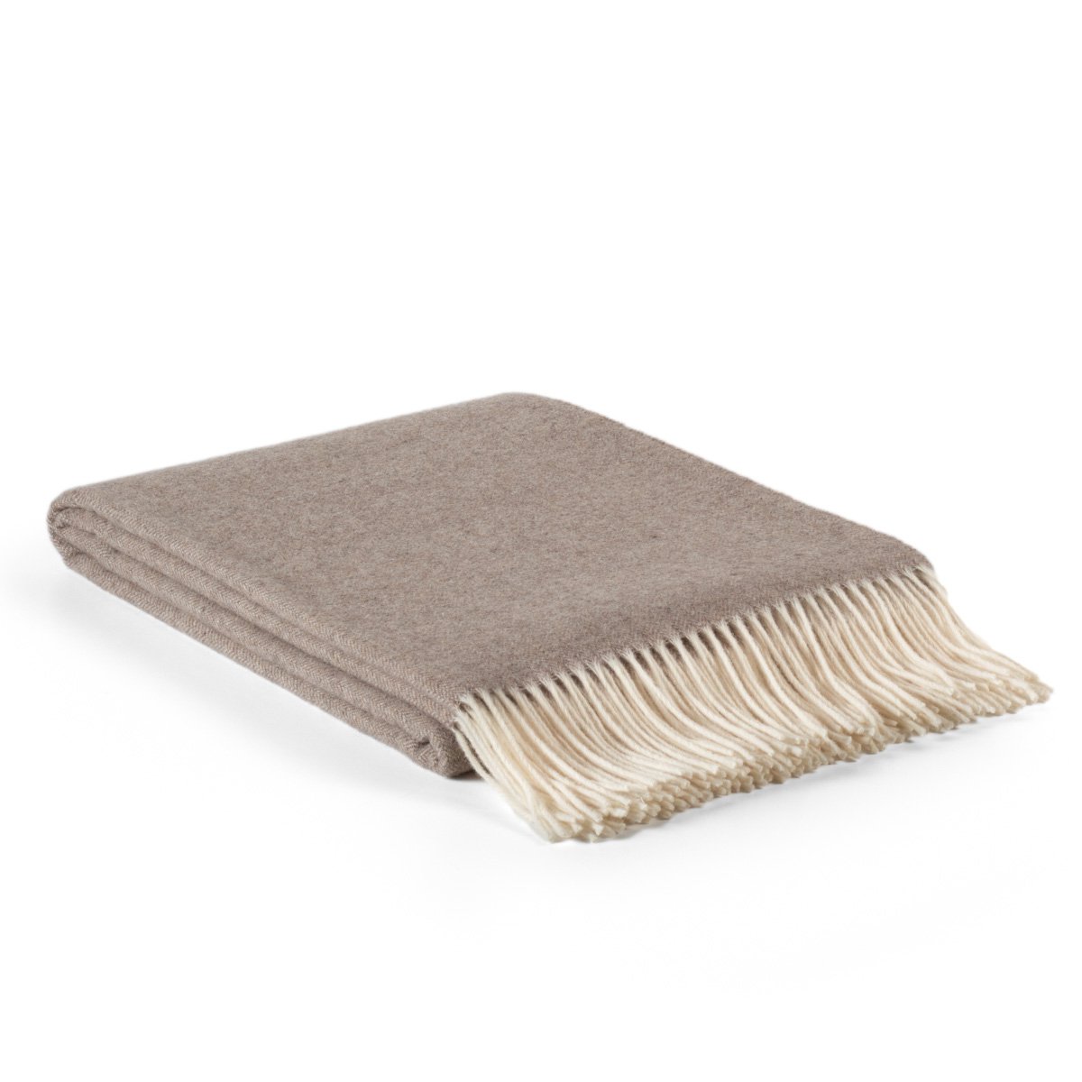 Folded beige blanket with white fringe on a white background