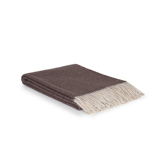 Folded brown blanket with white fringe on a white background