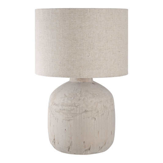 Table lamp with a textured beige base and shade on a white background
