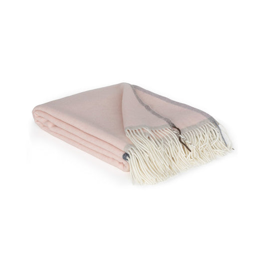 Folded pink blanket with white fringe on a white background