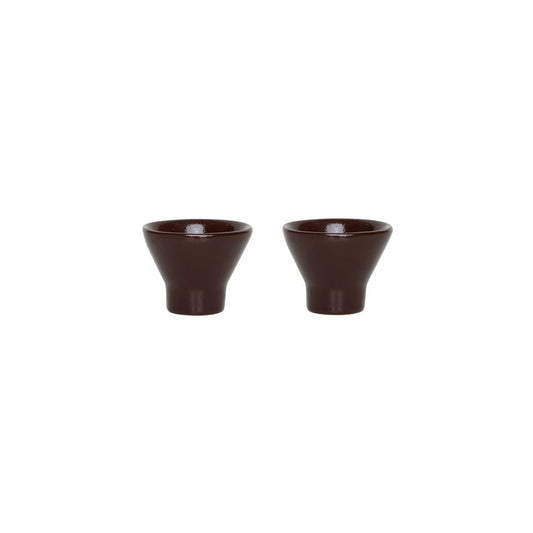 Two terracotta ceramic egg cups on a white background
