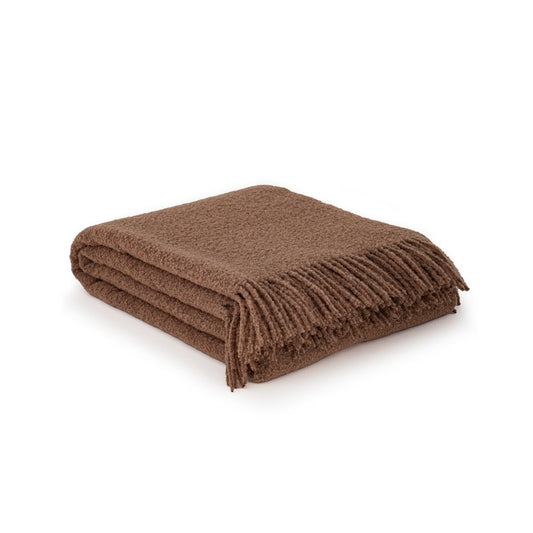 Folded brown blanket on a white background