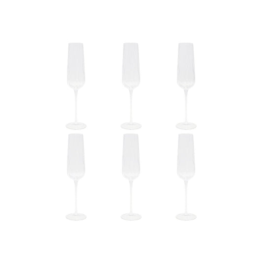 Set of four glass champagne flutes on a white background