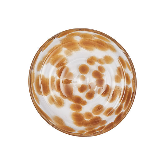 Round glass plate with amber marbled pattern on a white background