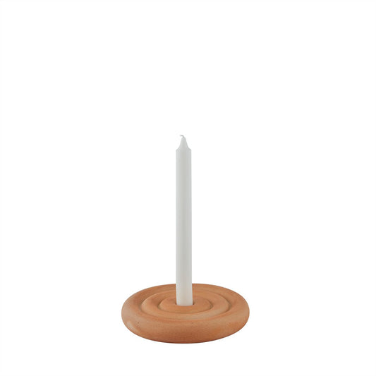 Ceramic candle holder with a white candle on a white background