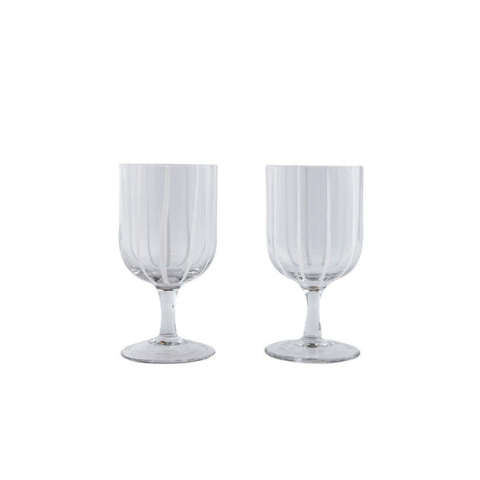 Two clear glass goblets with vertical stripes on a white background