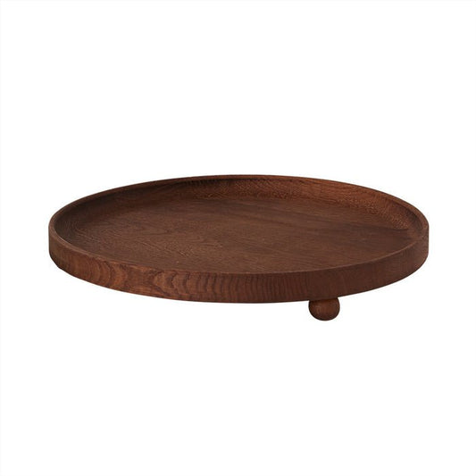 Wooden tray with a round base and raised edge on a white background