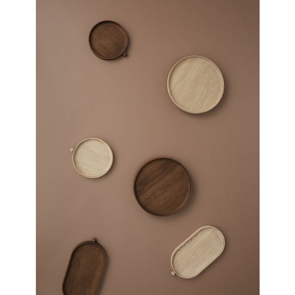Set of wooden trays in various shapes and sizes on a brown background
