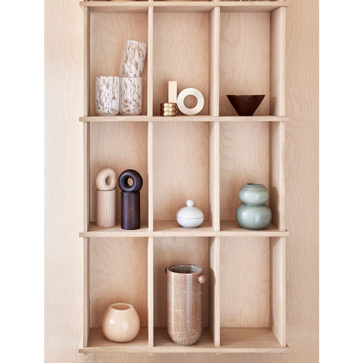 Wooden shelf with various ceramic items on a white background