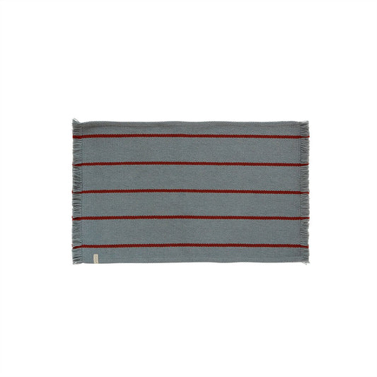 Striped bath mat with red and blue stripes on a white background
