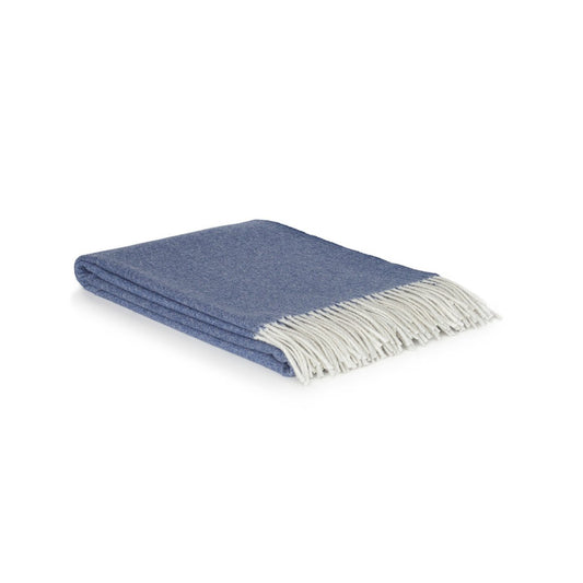 Blue throw blanket with white fringe on a white background