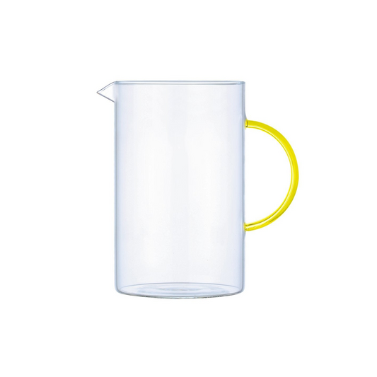 Clear glass pitcher with a yellow handle on a white background