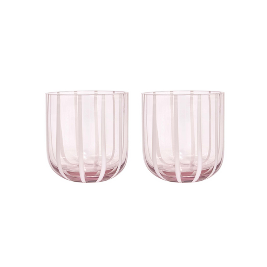 Two pink glass tumblers with striped design on a white background